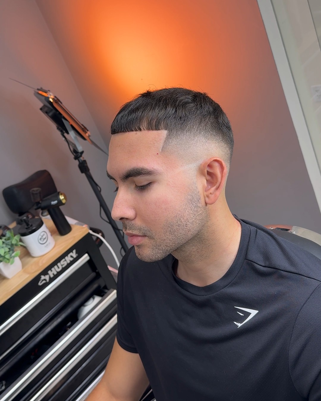 Sharp skin fade with a clean hard part by Cuts By Cello