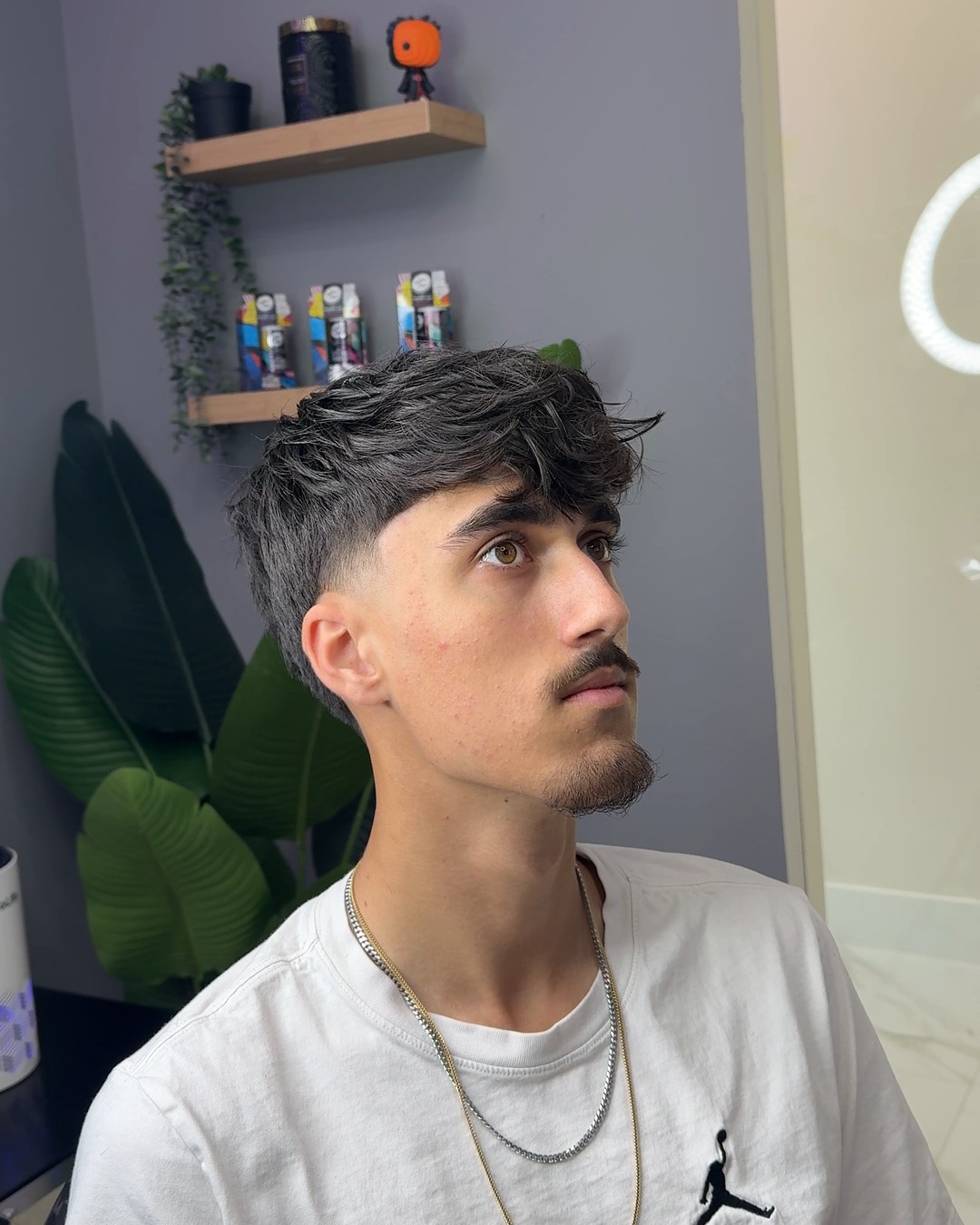 Textured fringe with a fade and mustache cleanup by Cuts By Cello